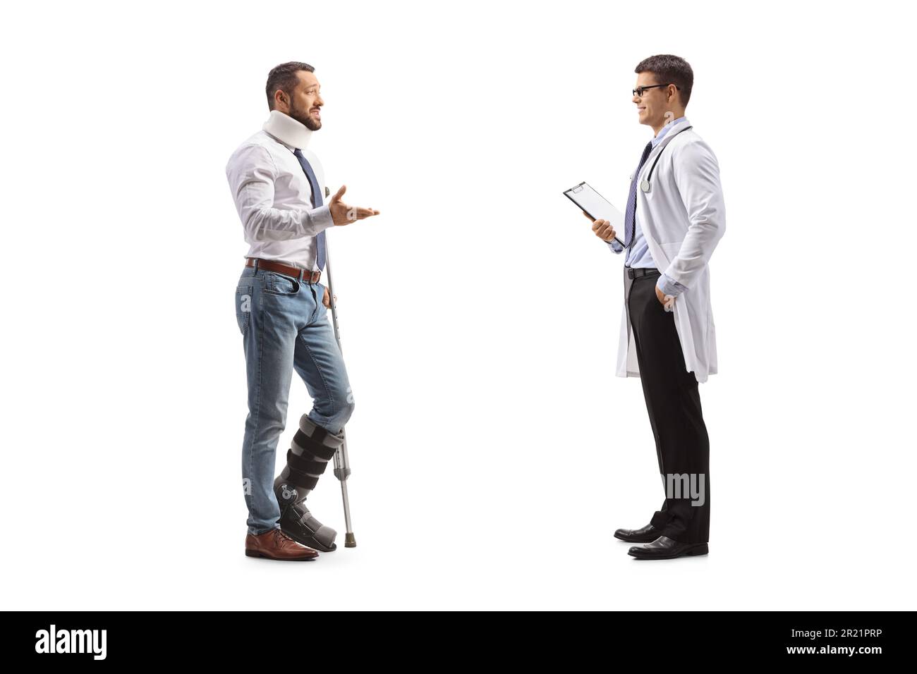 Injured male patient with an orthopedic boot and cervical collar talking to a male physician isolated on white background Stock Photo