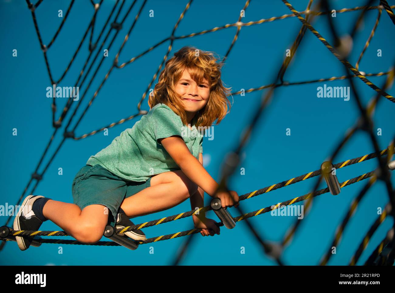 Happy Child Rope Happy child boy playing on the rope outdoor playground Stock Photo - Alamy