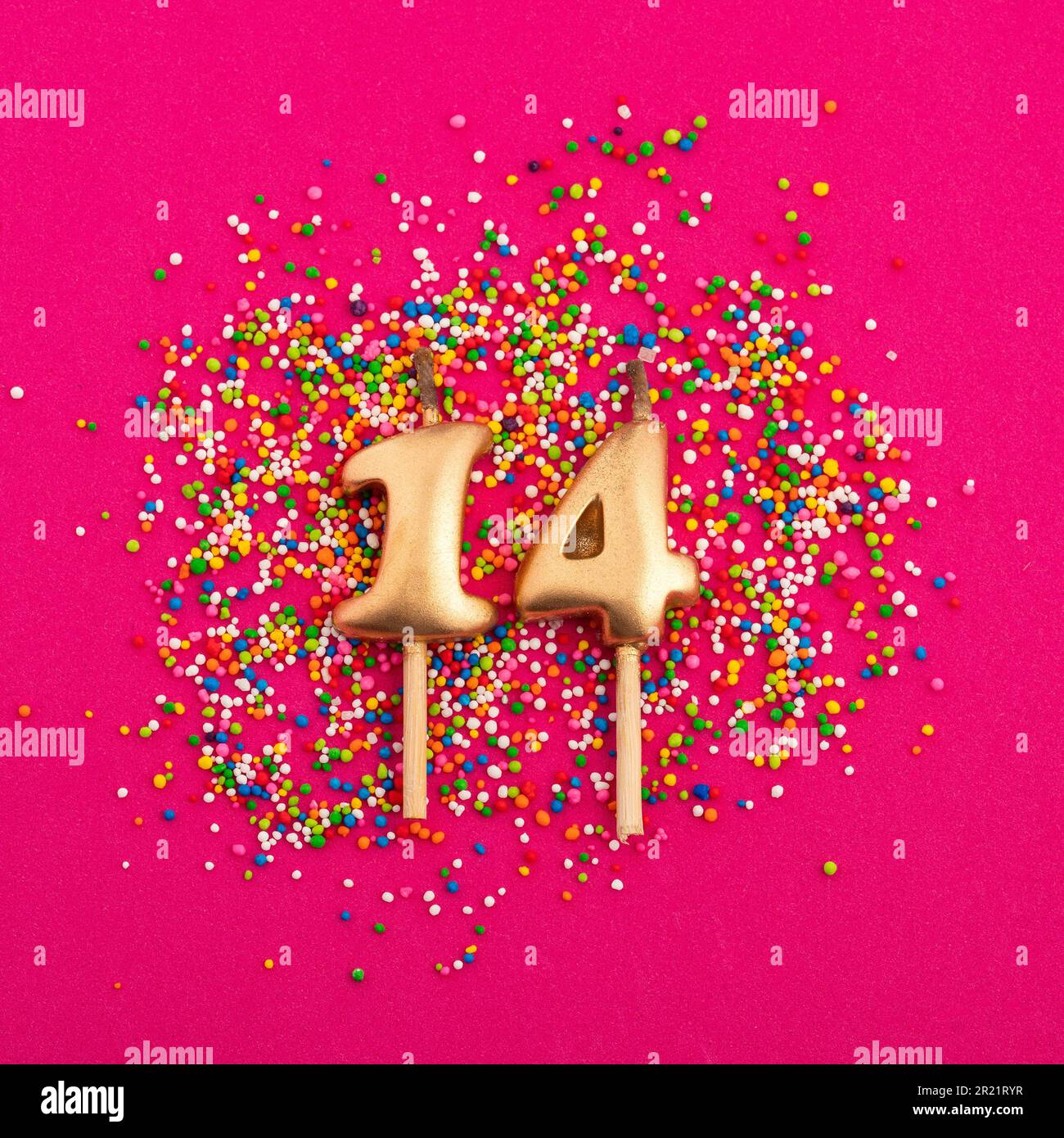 Birthday candle number 14 Anniversary celebration in rhodamine red background Stock Photo Alamy