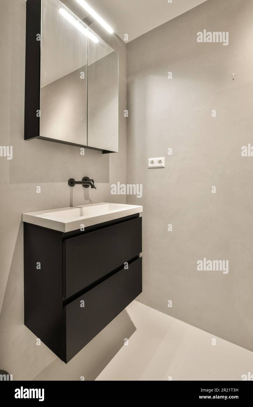 a modern bathroom with black and white countertops on the wall