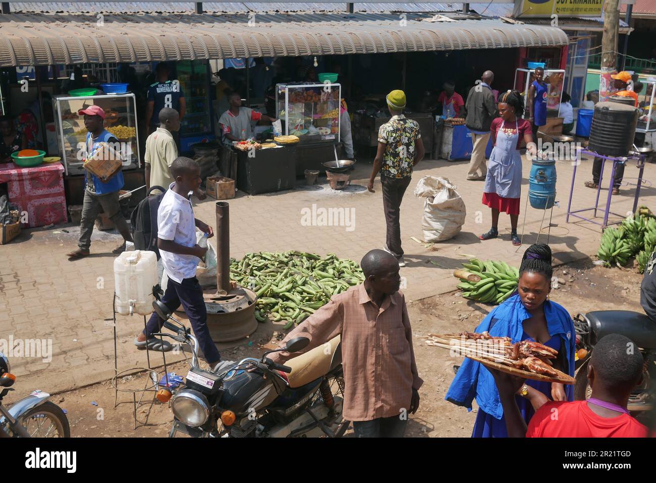 Hawkers and street vendors approach a bus in Uganda Stock Photo - Alamy