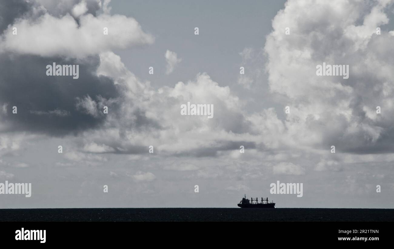 a cargo ship on the horizon Stock Photo - Alamy