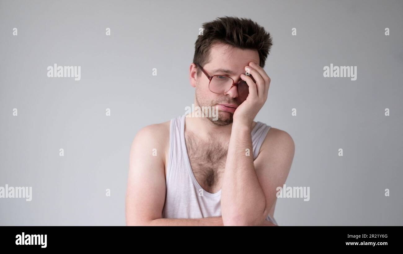 the tired European young man looks dejectedly, without strength and energy Stock Photo