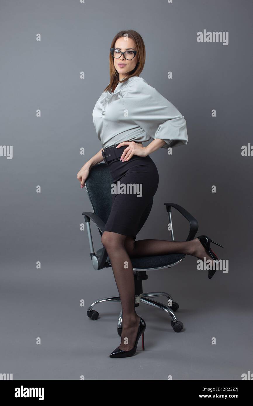 Proud 30s Caucasian businesswoman posing on chair Stock Photo