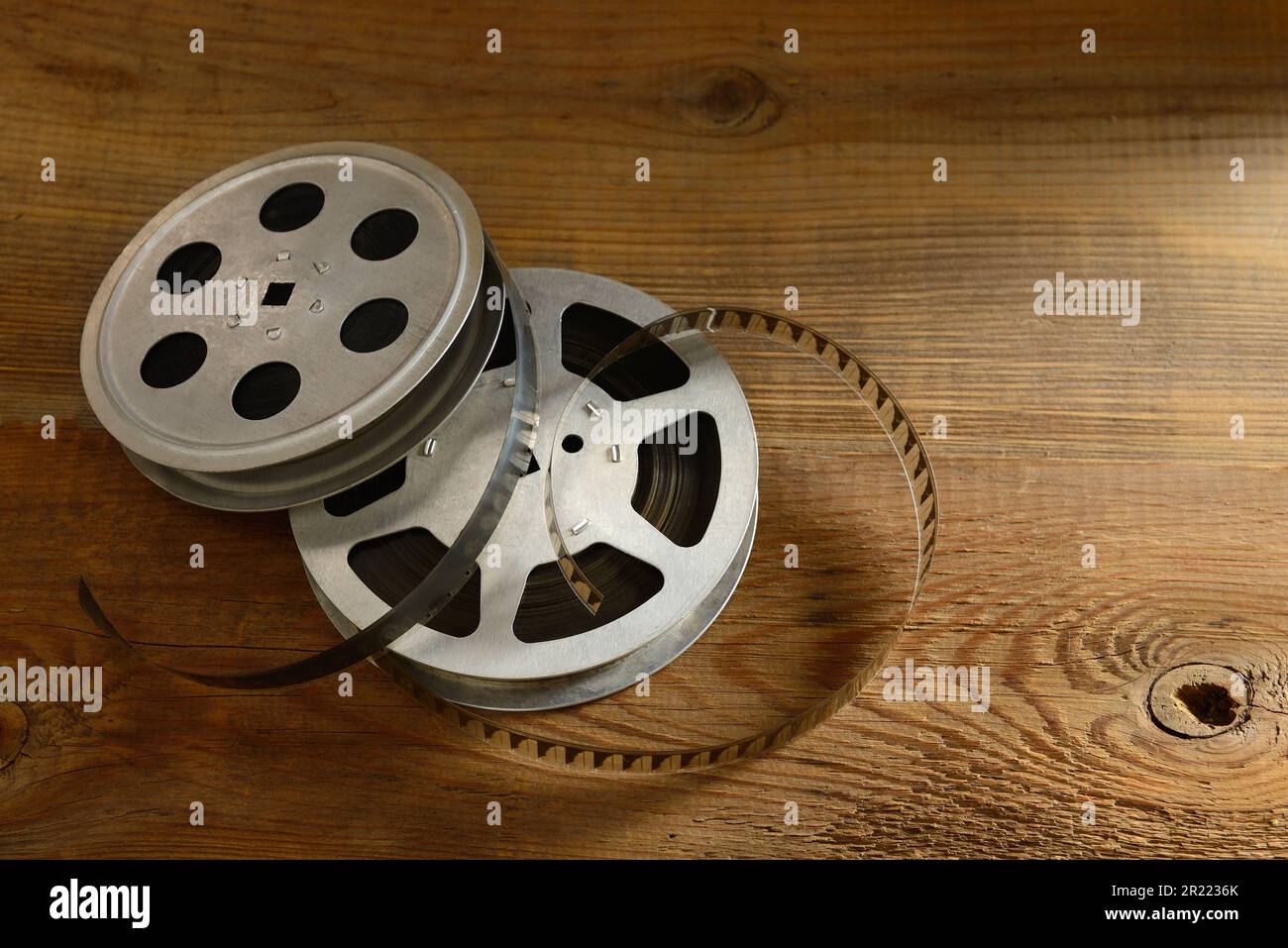 Old film strip on natural wooden background. Stock Photo