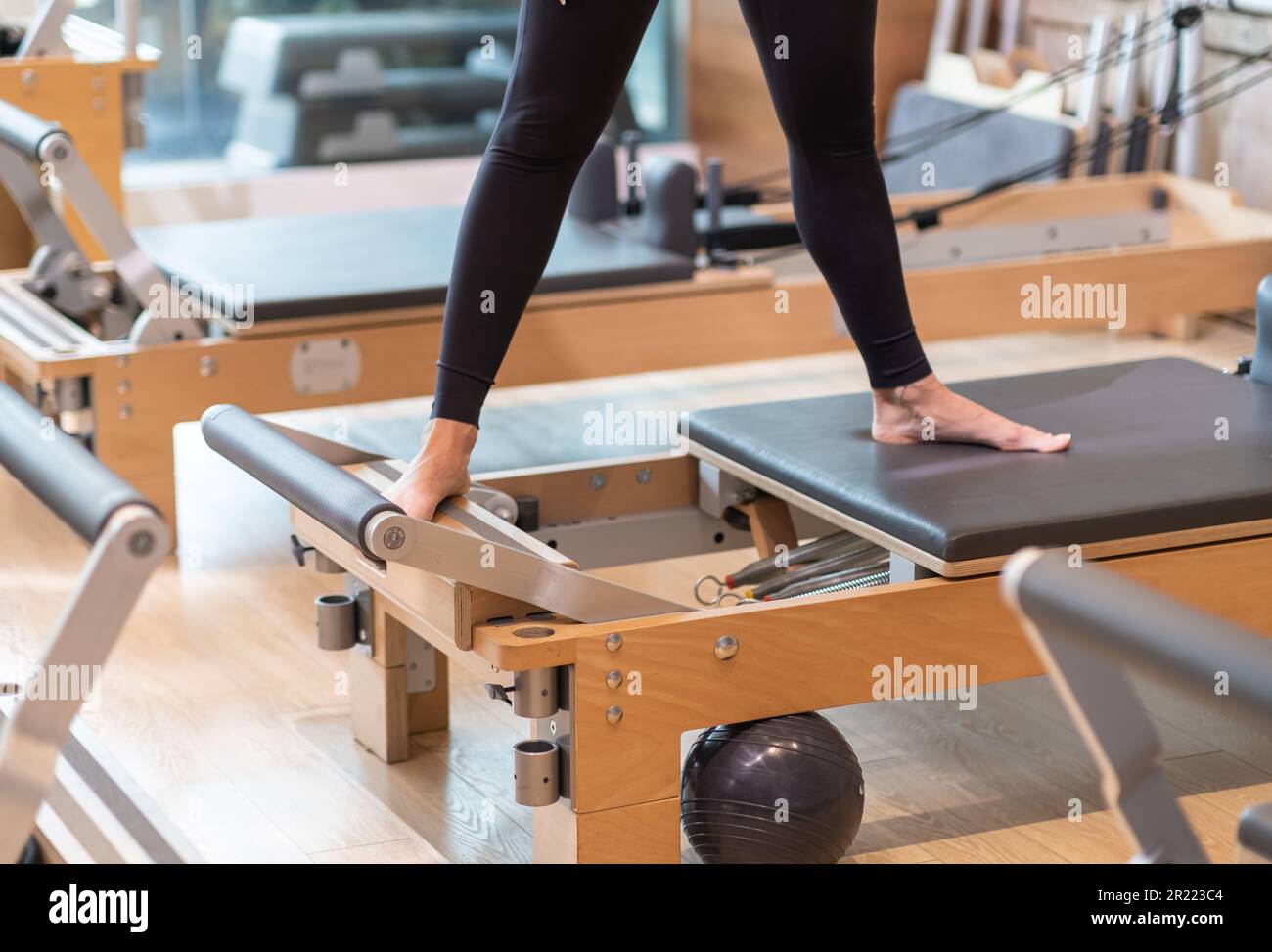 Professional pilates exercise for flexible body woman stretching legs