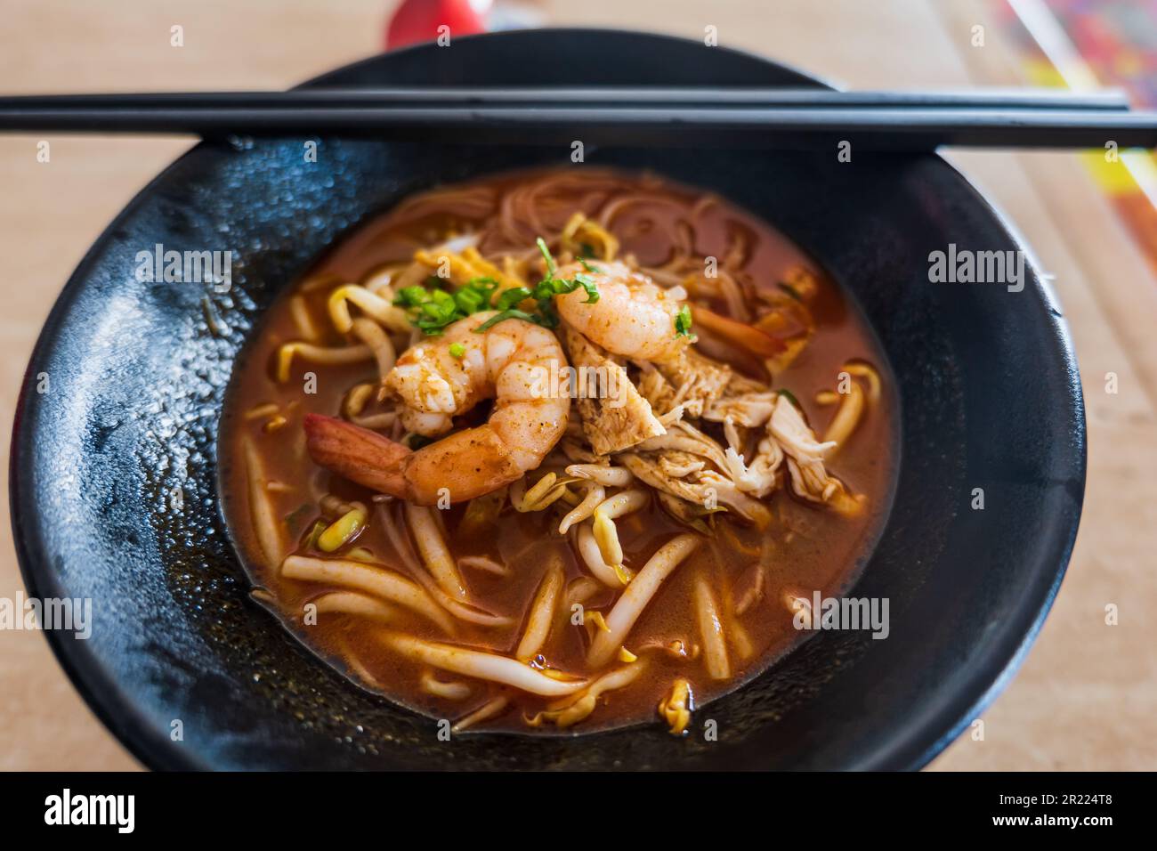 Sarawak Laksa soup in street food kitchen, in Malaysia. Laksa is a