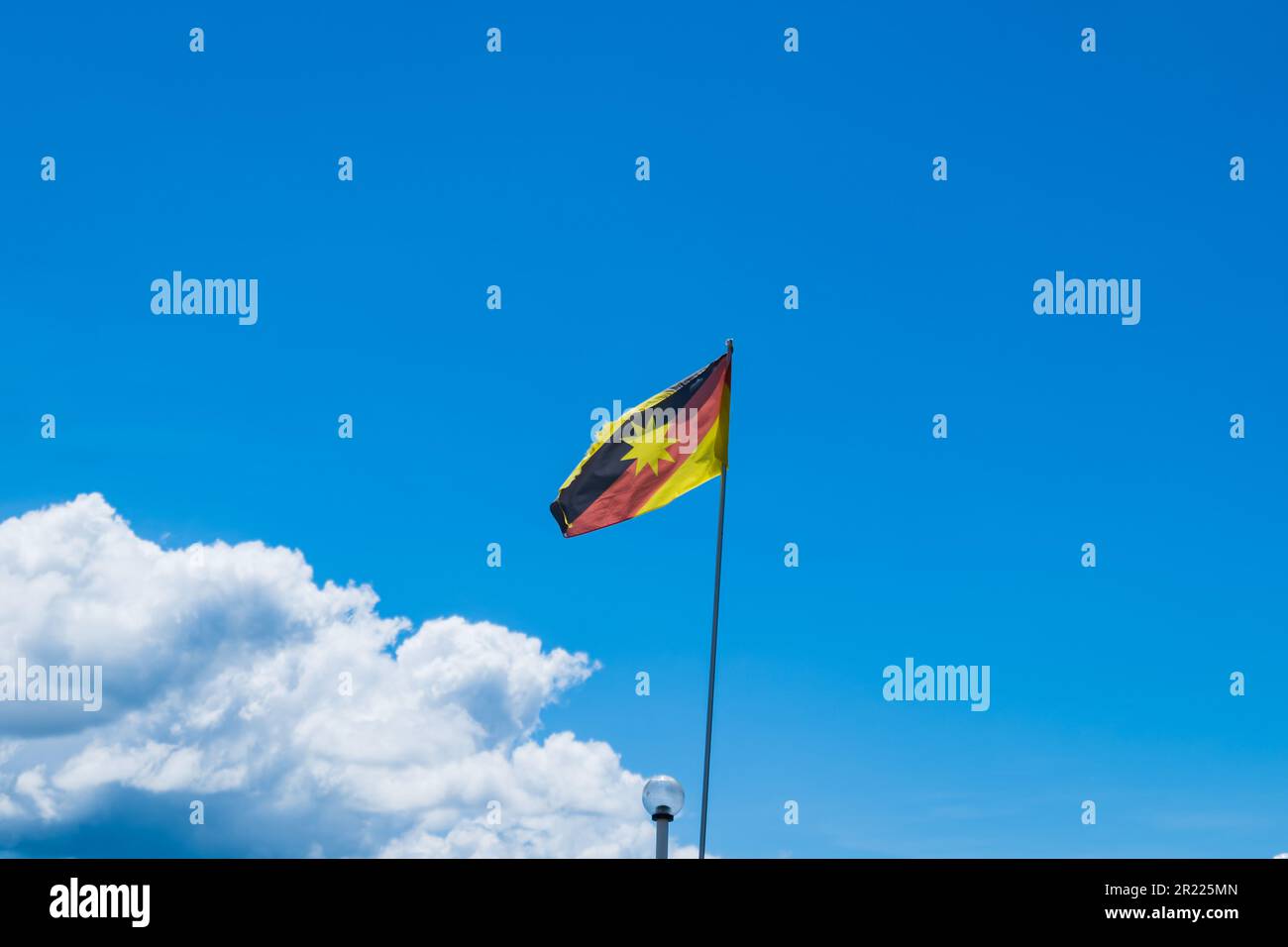 Sarawak flag waving against blue sky, flag of the Sarawak state, East Malaysia Stock Photo
