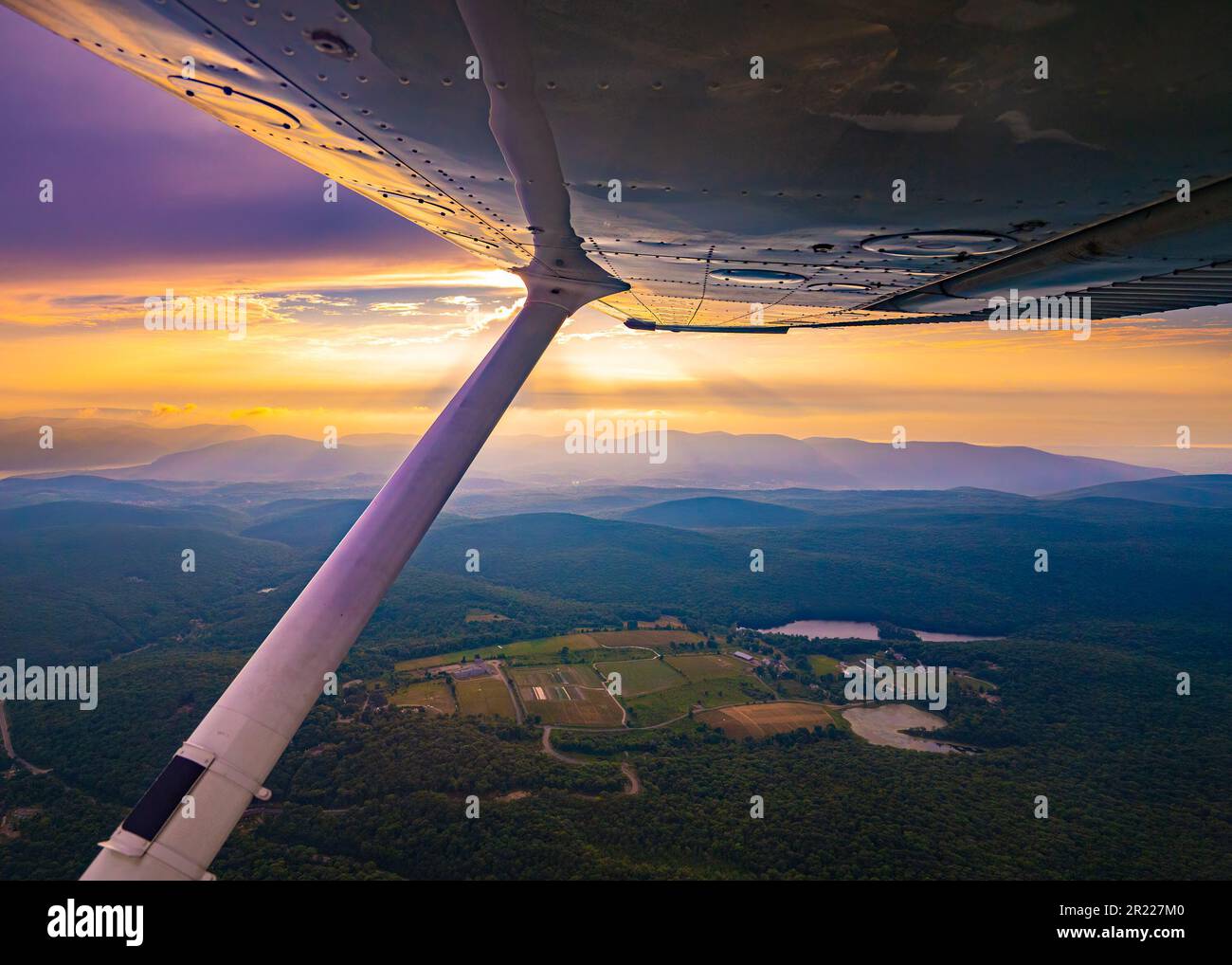 Aerial view of colorful sky at sunset as seen from a single engine ...