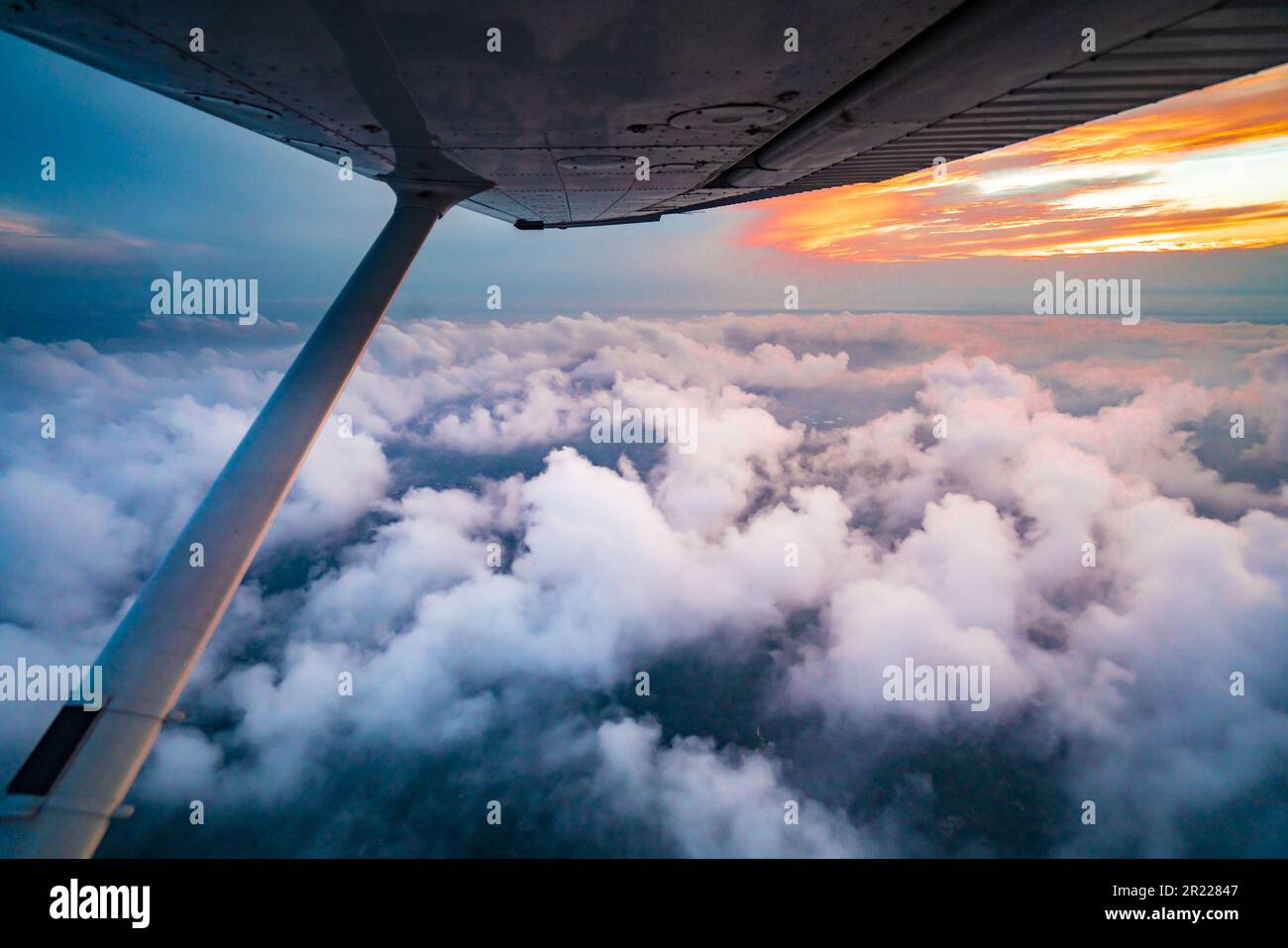Aerial view of colorful sky at sunset as seen from a single engine plane, Stock Photo