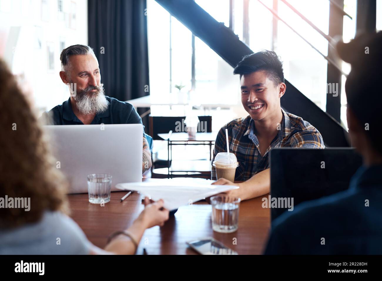 Theyre all on the same page. a group of designers having a meeting in ...