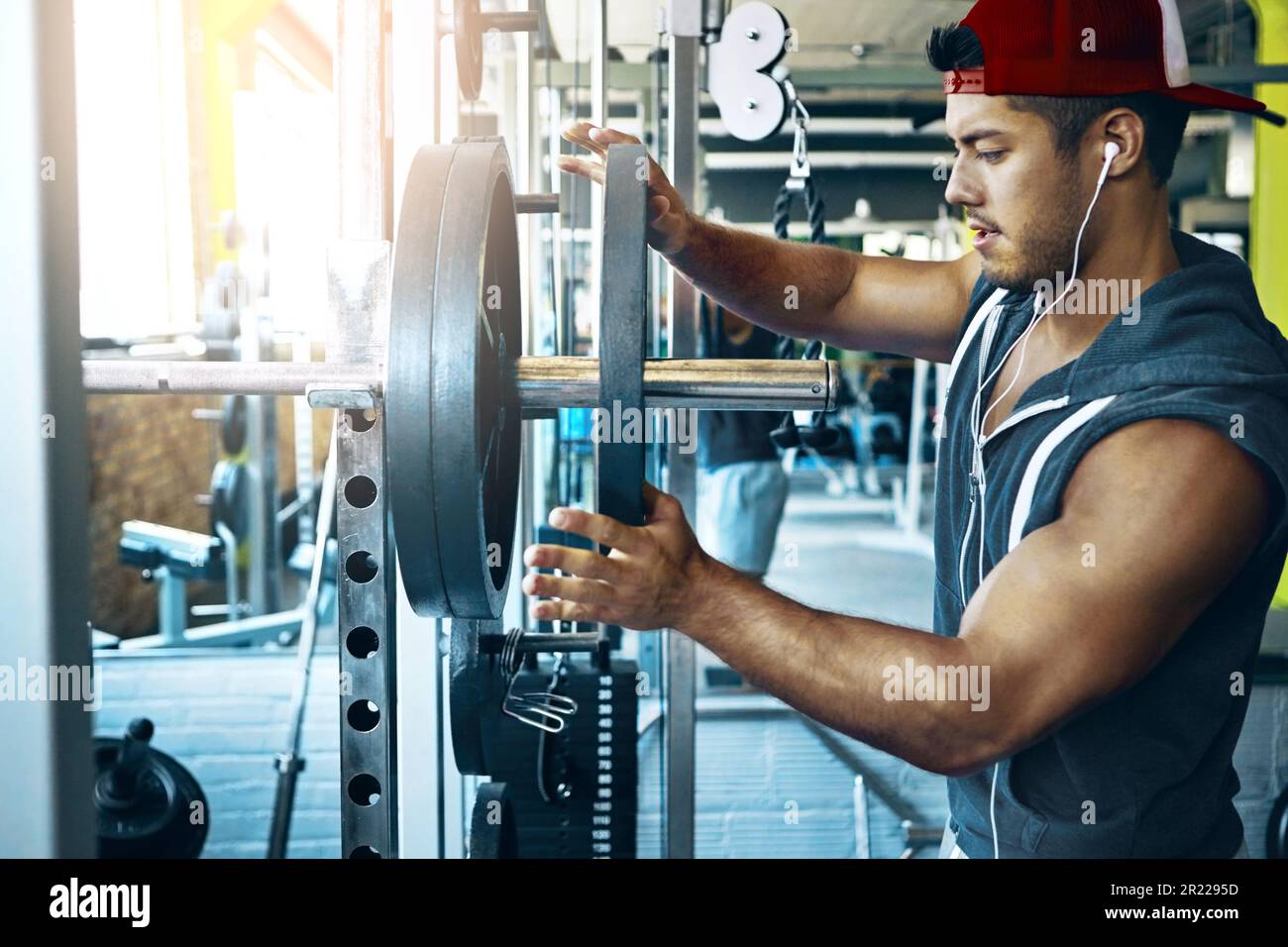 Time to pump up the volume. a man doing weight training at the gym