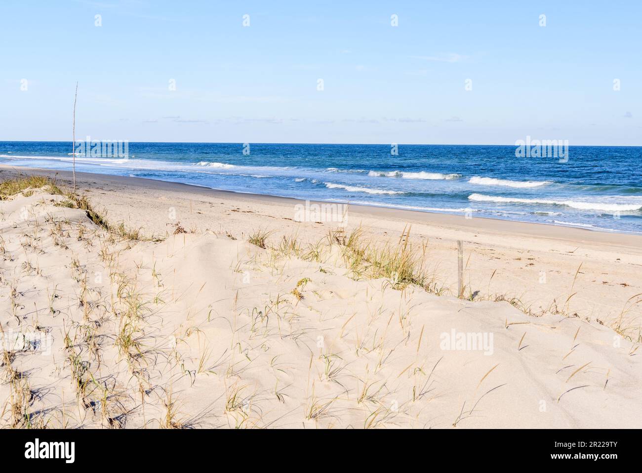 Empty stretch of a sandy beach on a clear autumn day Stock Photo