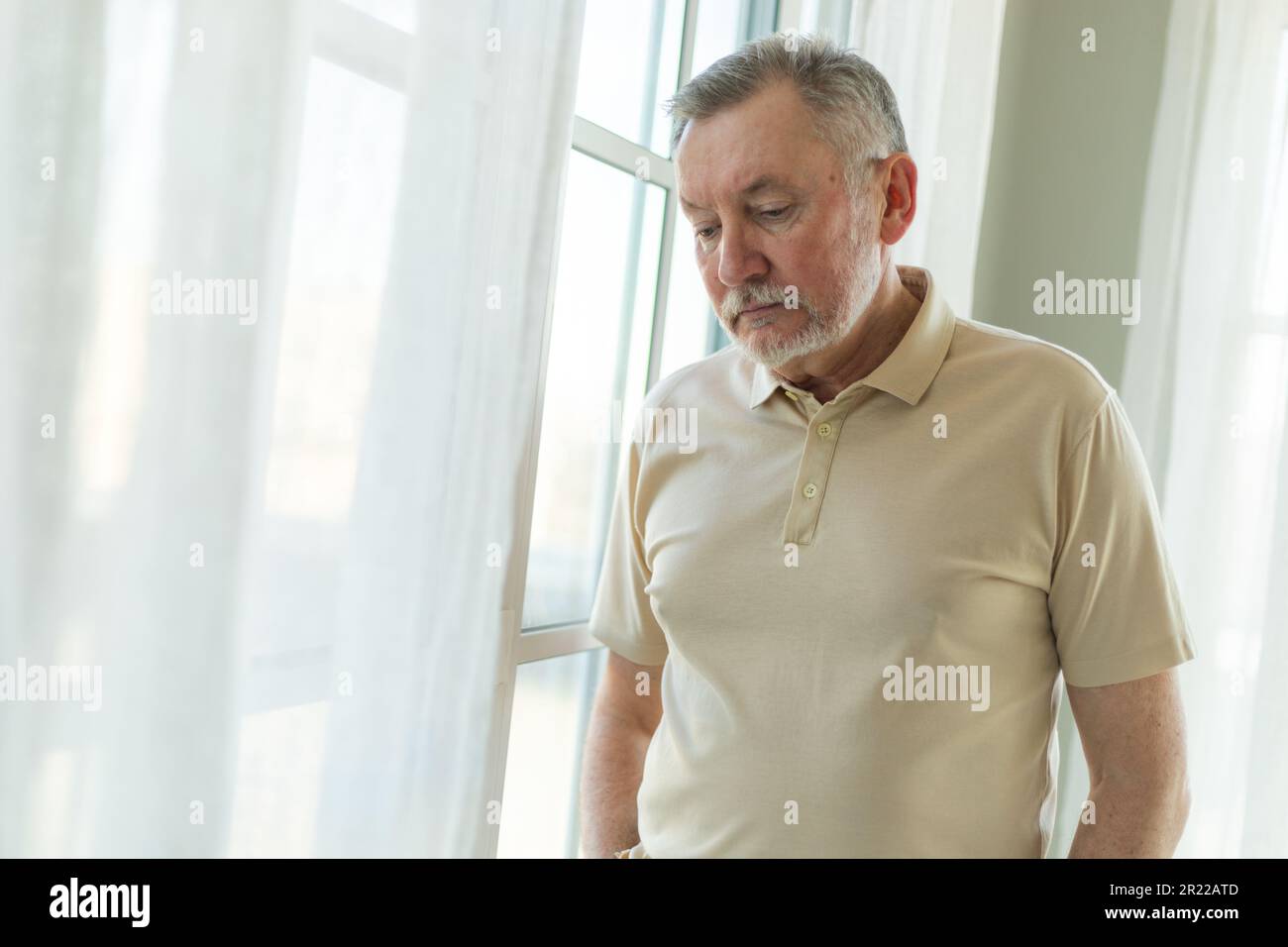 Sad tired lonely disappointed older senior man at home alone. Unhappy  grandfather looking sadly outside window experiencing grief relative death  bad news. Stressed elder man suffering from loneliness Stock Photo - Alamy