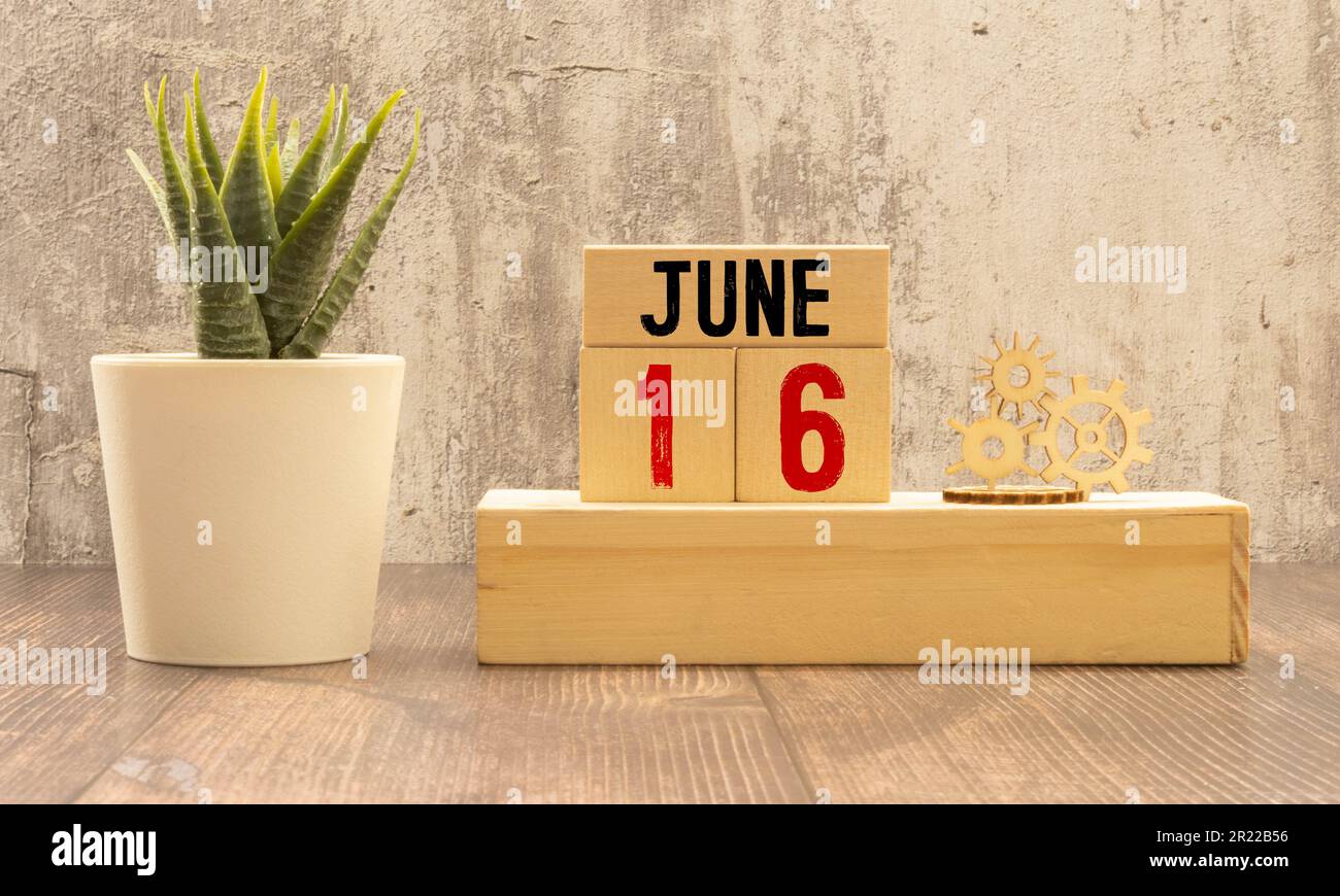Cup with decorative mustache, gift box and wooden calendar on white table against blue background, space for text Stock Photo
