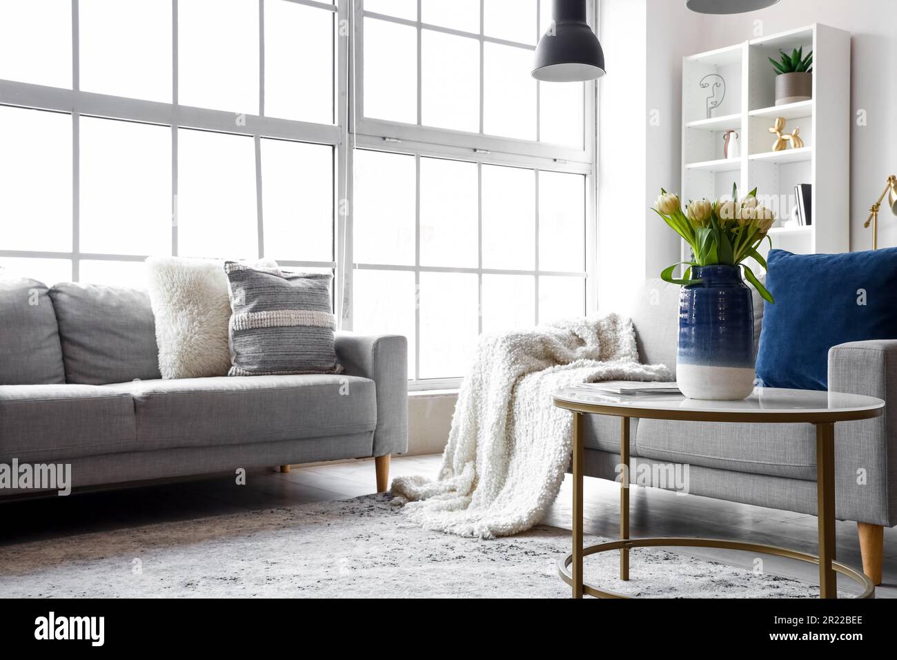 Interior of bright living room with cozy sofas and coffee table near ...