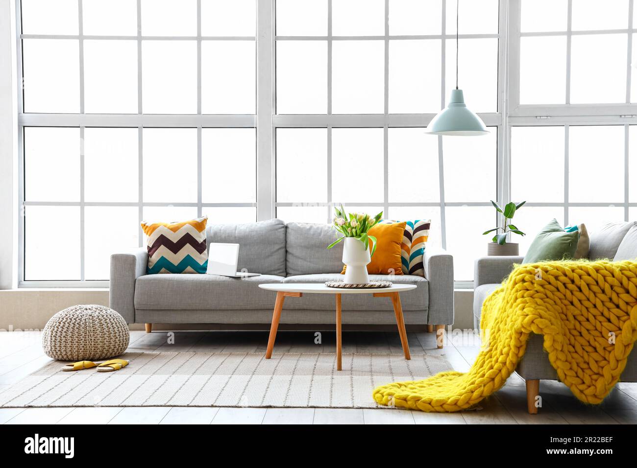 Interior of bright living room with cozy sofas and coffee table near ...
