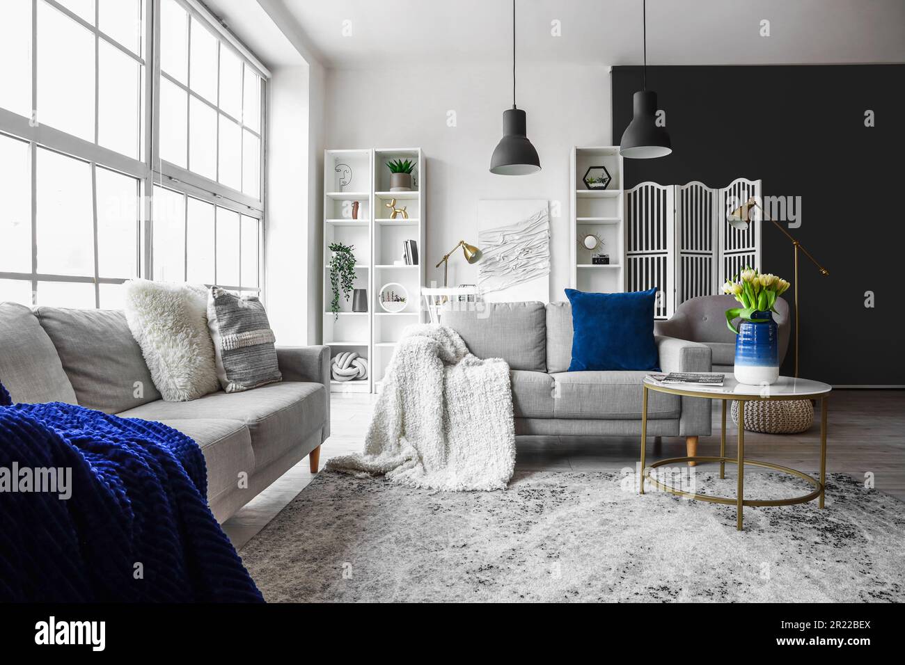 Interior of bright living room with cozy sofas and coffee table near ...