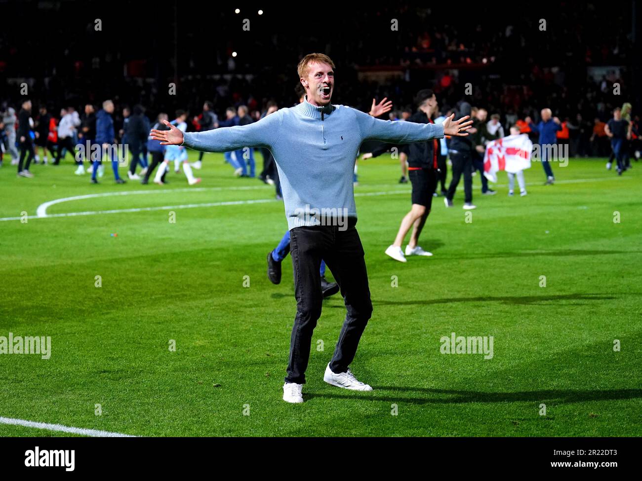 A Luton Town fan invades the pitch as they celebrate securing their