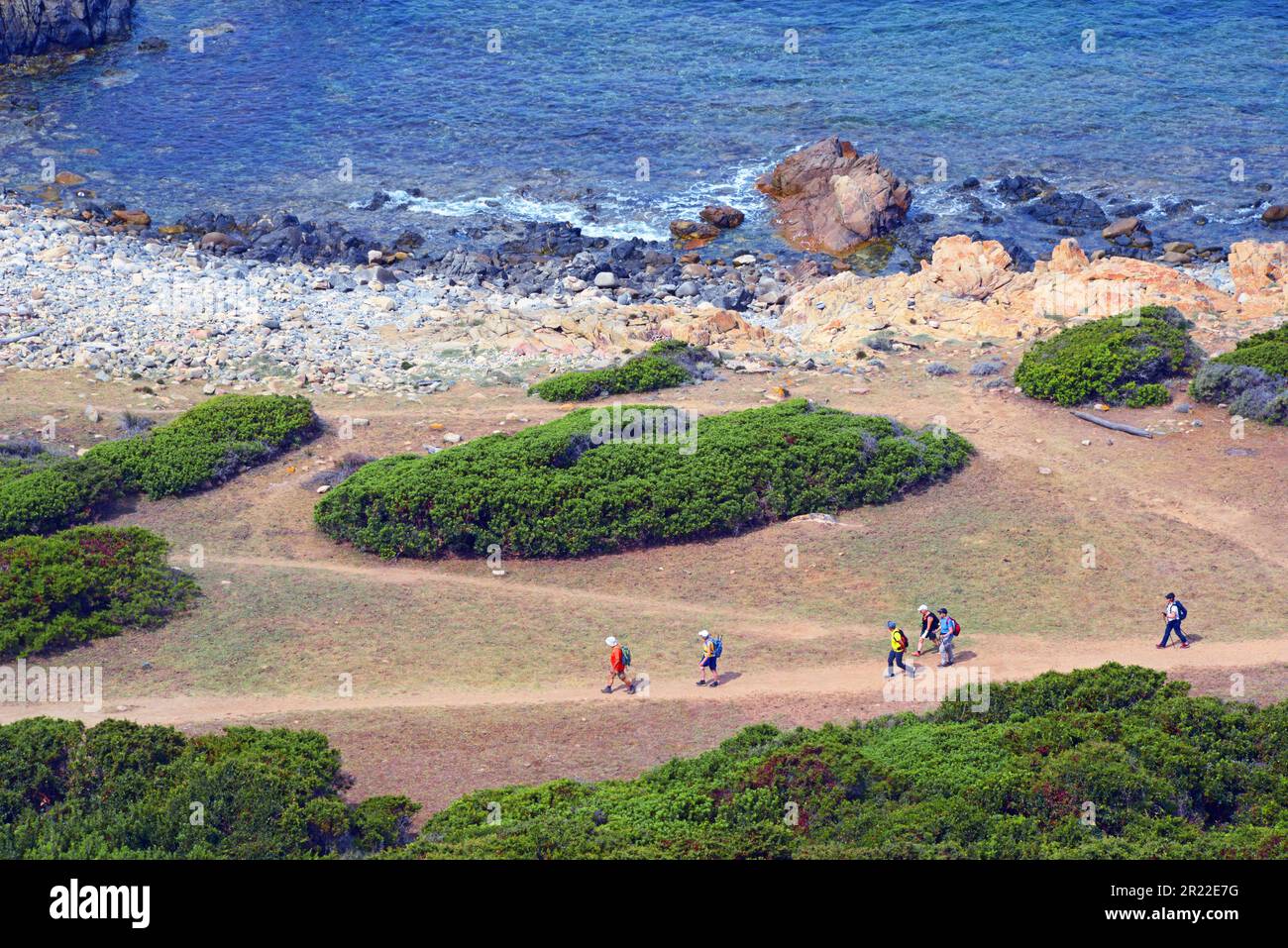 wanderers on footpath along the coast in the bay of Valinco, France, Corsica, Campomoro Stock Photo
