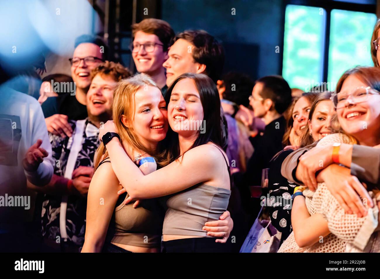 People hug each other as the Ukrainian band GO A performs during the night termed 'support each other'. The Ukrainian band GO A, played exclusively for Ukrainian students at Breda University of Applied Sciences. The band wanted to bring the Ukrainian students together during the night to support each other. During the event, there was a voluntary collection of funds for the support of Ukraine, all donated to the "Sails of Freedom" Foundation in the Netherlands. The charity performance was possible with the support of the rector of Breda University of Applied Sciences and the mayor of the city. Stock Photo