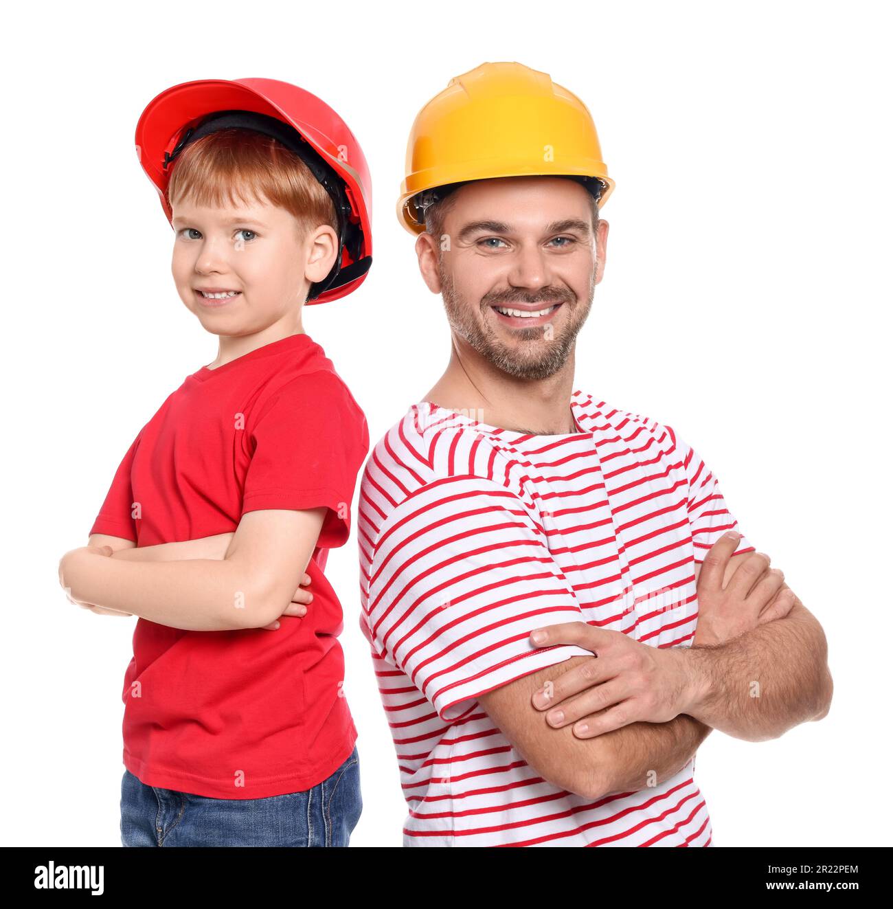 Father and son wearing hard hats on white background. Repair work Stock