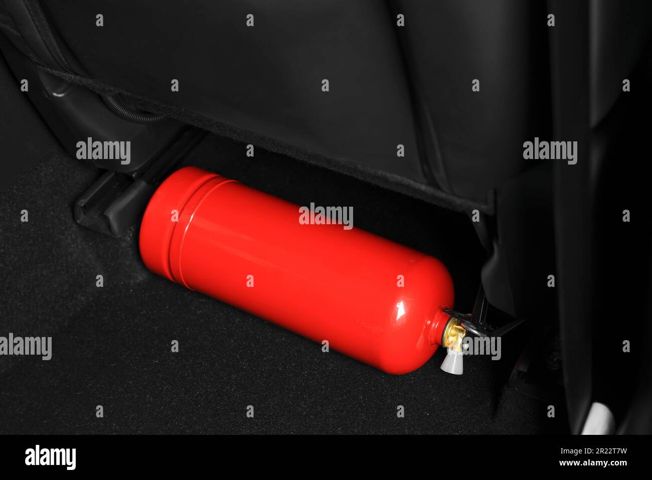 Red fire extinguisher in trunk. Car safety equipment Stock Photo Alamy
