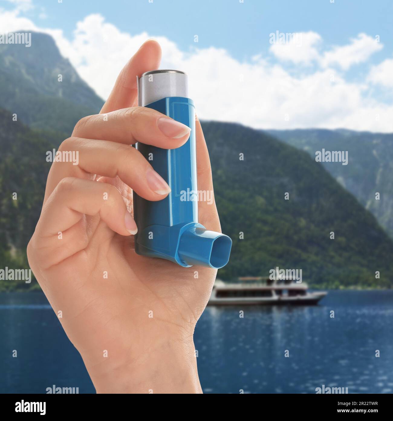Woman with asthma inhaler near lake, closeup. Emergency first aid