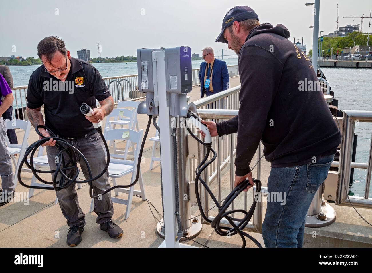 Detroit, Michigan, USA. 16th May, 2023. The United States and Canada announced plans for a binational electric vehicle corridor, with DC fast charging stations every 50 miles from Kalamazoo, Michigan to Quebec City, Quebec. Electrical workers, members of IBEW, set up an EV charger before the event. Credit: Jim West/Alamy Live News Stock Photo