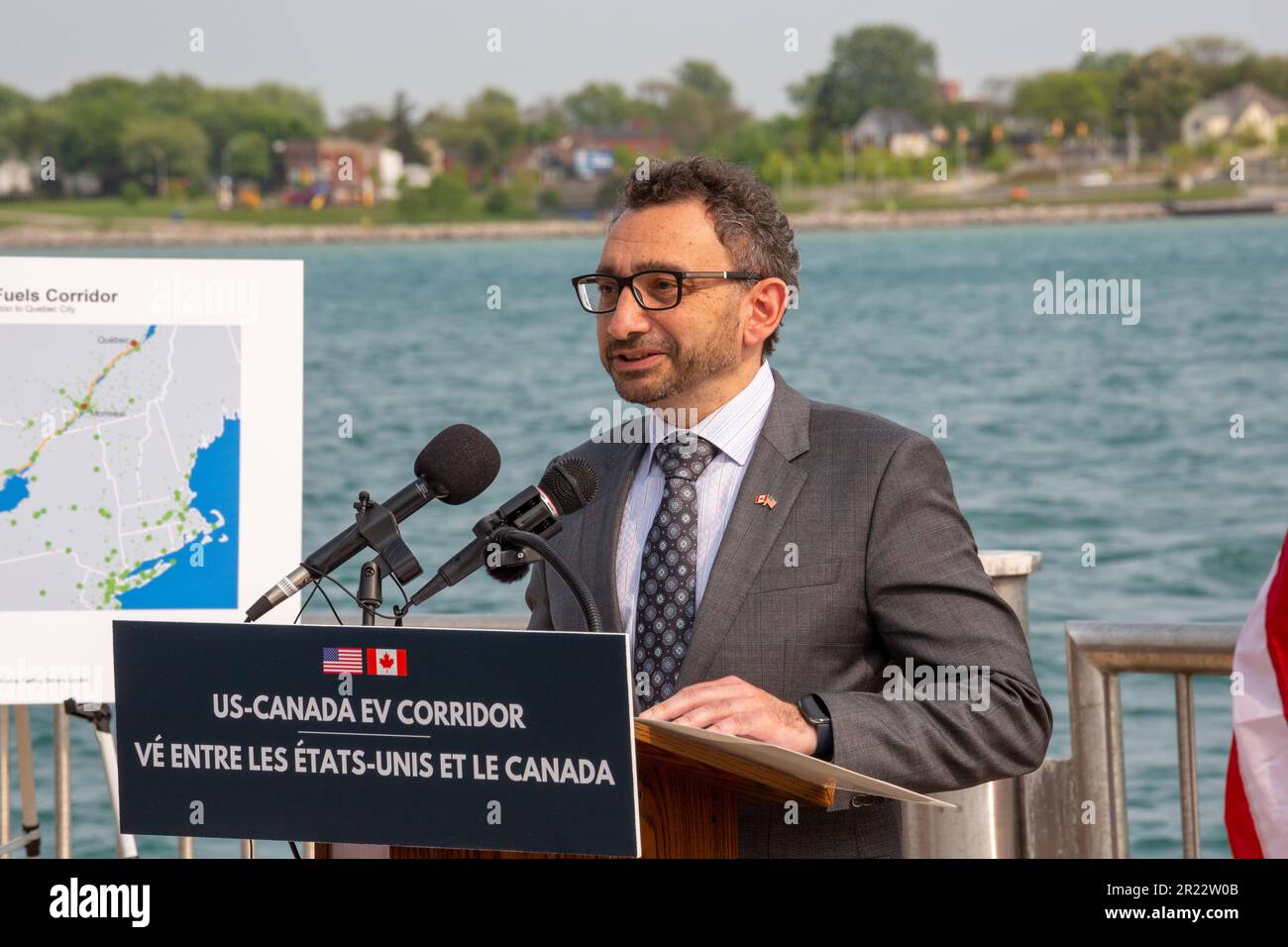 Detroit, Michigan, USA. 16th May, 2023. The United States and Canada announced plans for a binational electric vehicle corridor, with DC fast charging stations every 50 miles from Kalamazoo, Michigan to Quebec City, Quebec. Making the announcement at a dock on the Detroit River (with Canada across the river) were Canadian Minister of Transport Omar Alghabra and U.S. Transportation Secretary Pete Buttigieg (not pictured). Credit: Jim West/Alamy Live News Stock Photo