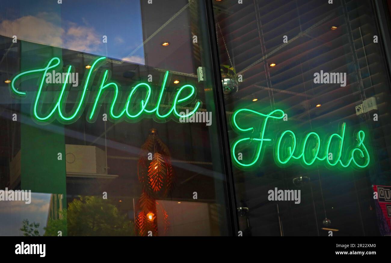Green neon sign in Vegetarian restaurant, Liverpool - Whole Foods Stock Photo
