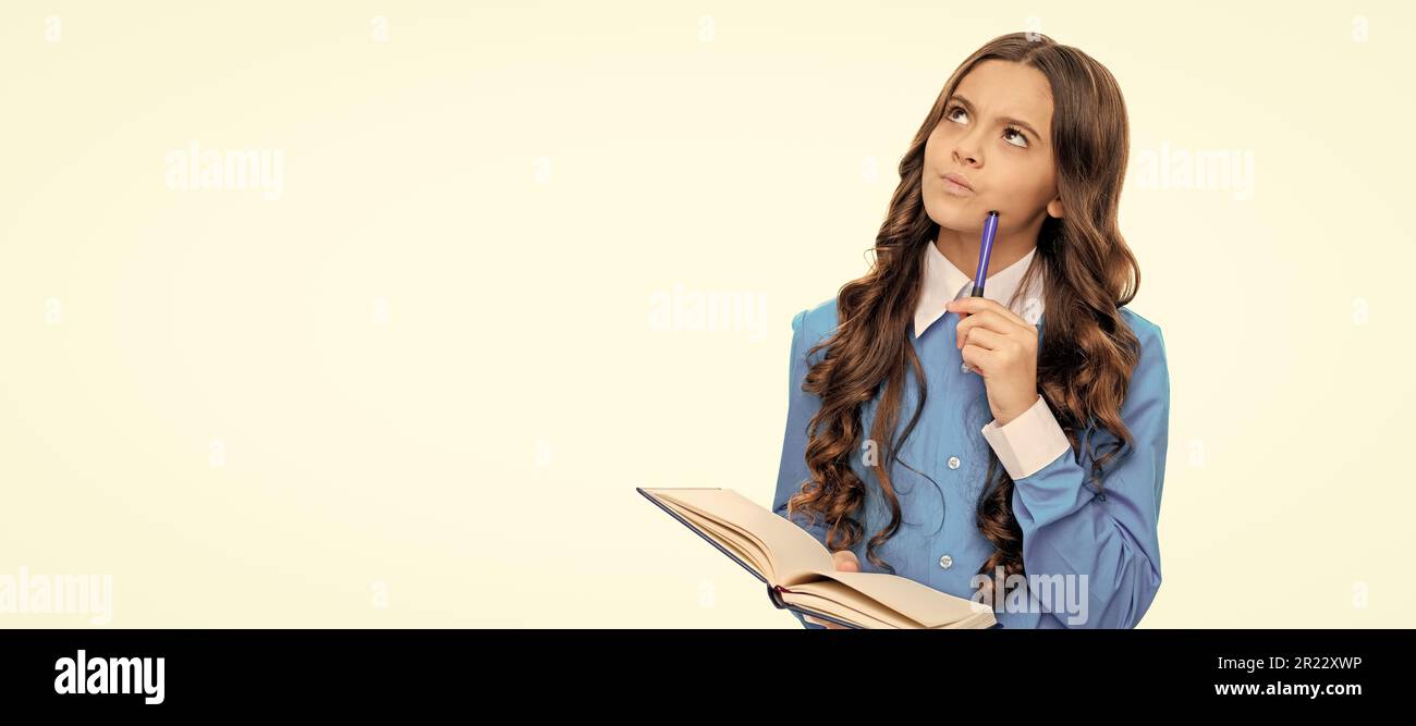 Thinking kid solve mathematical problem holding school book isolated on white. Portrait of schoolgirl student, studio banner header. School child face Stock Photo