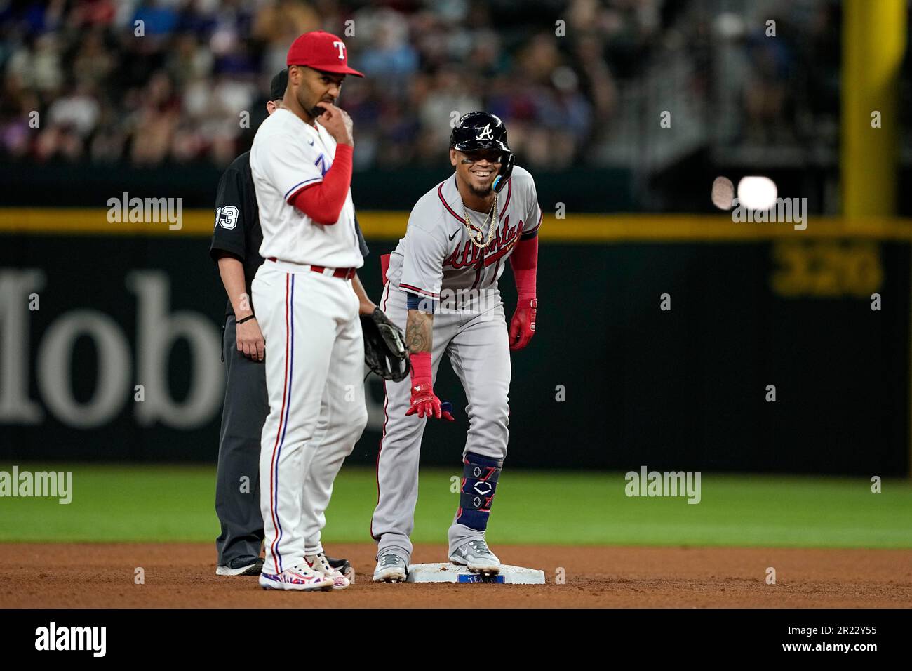 Atlanta Braves' Orlando Arcia (11) celebrates with first base coach Eric  Young Sr. (2) after driving in a run with a single in the eighth inning of  a baseball game against the