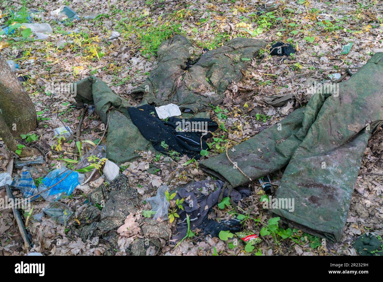 May 15, 2023, Kharkiv region, Ukraine: Clothes left by Russiann forces during occupation near village of Sulyhivka, Kharkiv region of Ukraine. Russian forces hasty retreated leaving behind ammunition, tanks, garbage, shoes, sleeping bags, and etc. Ukrainian forces on this location found almost 30 tanks in good conditions they fixed and reuse against Russian army. (Credit Image: © Lev Radin/Pacific Press via ZUMA Press Wire) EDITORIAL USAGE ONLY! Not for Commercial USAGE! Stock Photo