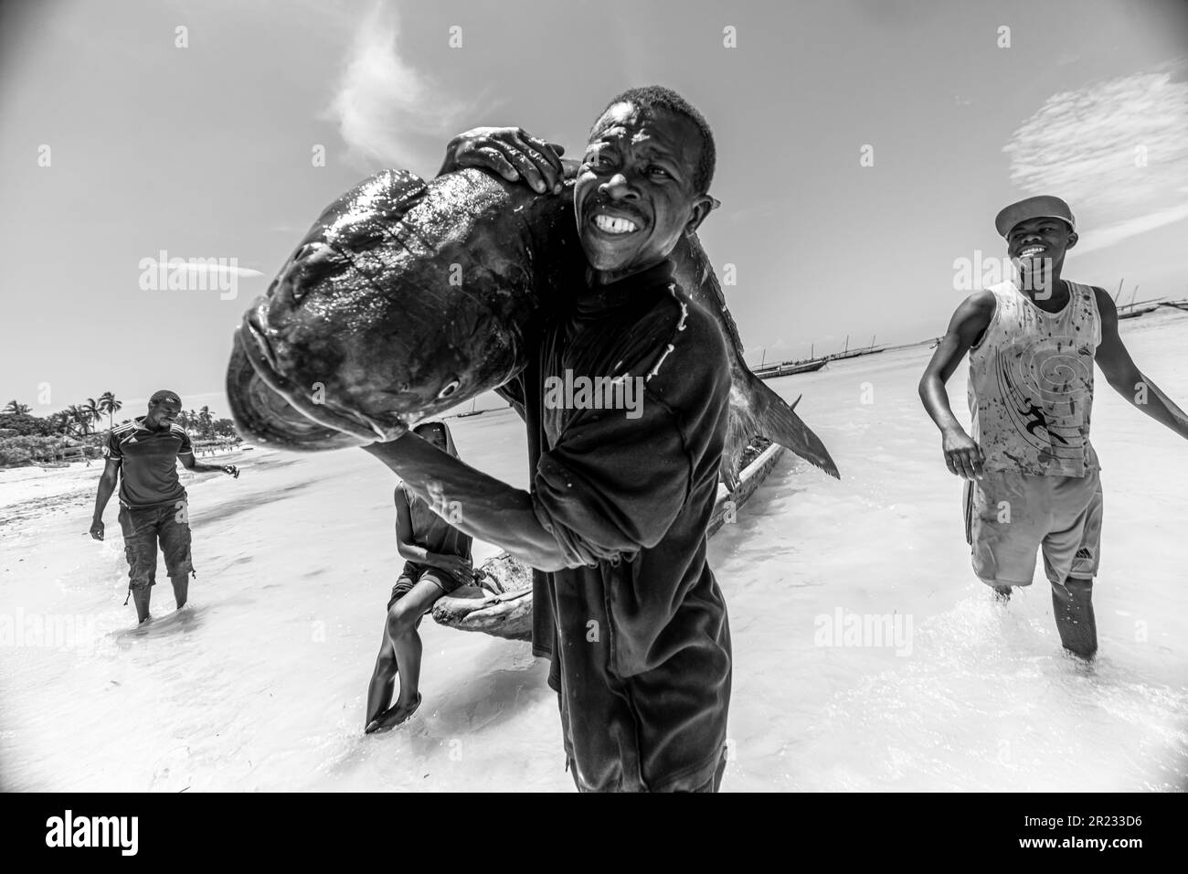 ZANZIBAR, TANZANIA - January 2021: African man runs with a rich catch in his hands. January, 17 Stock Photo