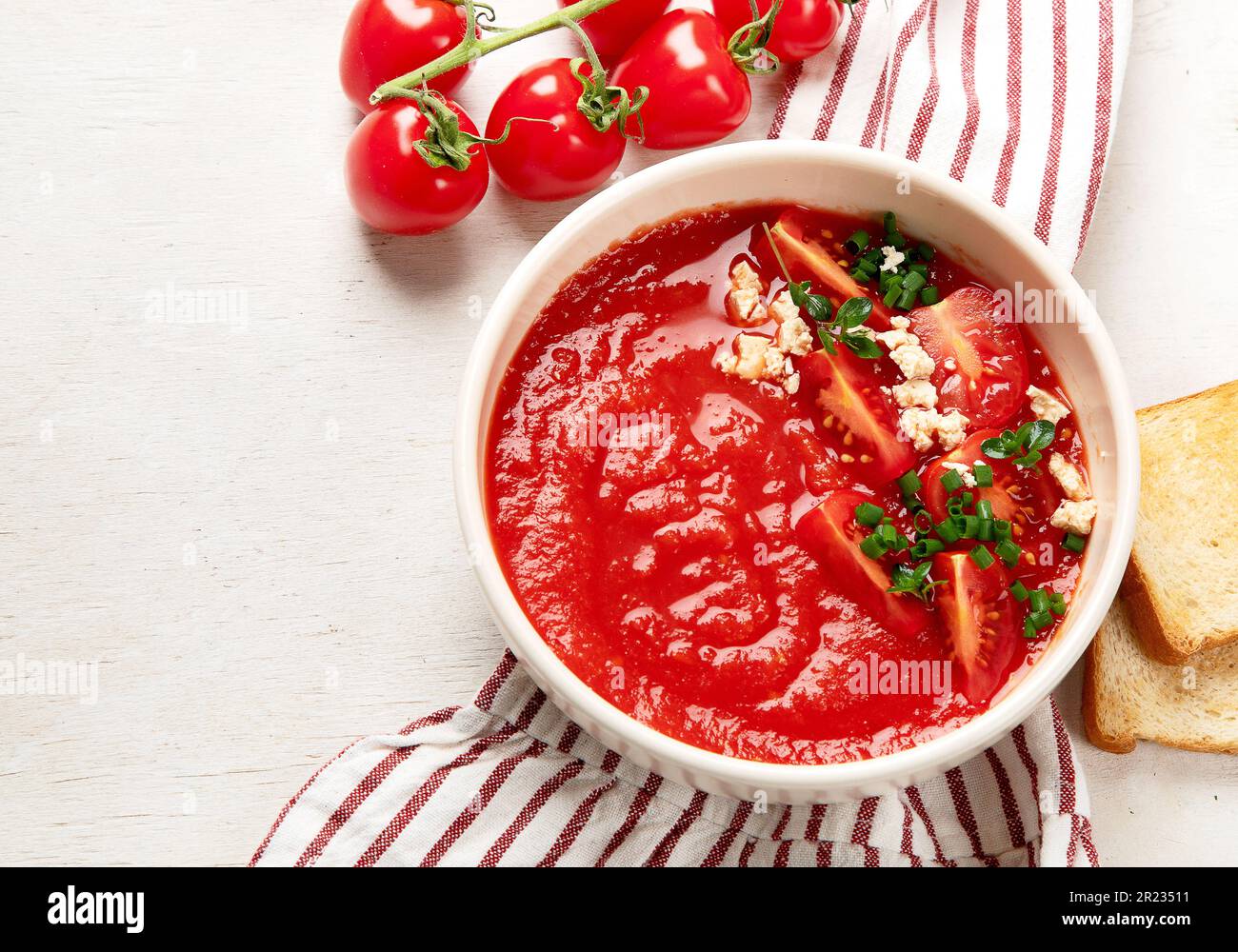 Tomato soup on white table, top view Stock Photo - Alamy