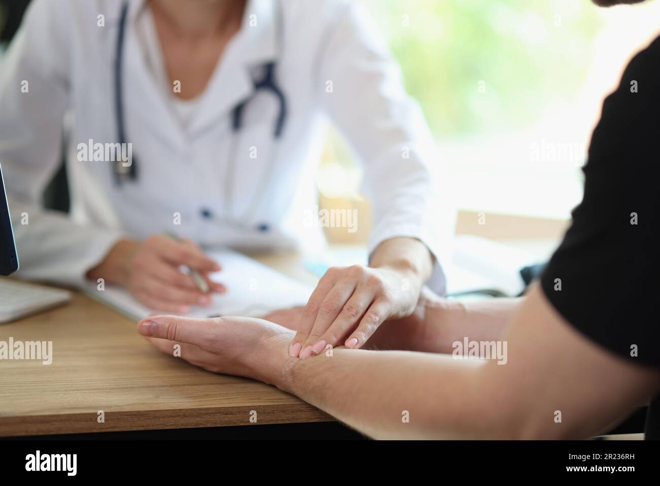 Therapist supports patient after revealing severe diagnosis Stock Photo