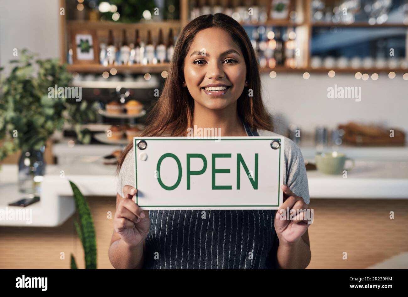 Happy woman, open sign and portrait at cafe of small business owner or waitress for morning or ready to serve. Female person or restaurant server Stock Photo
