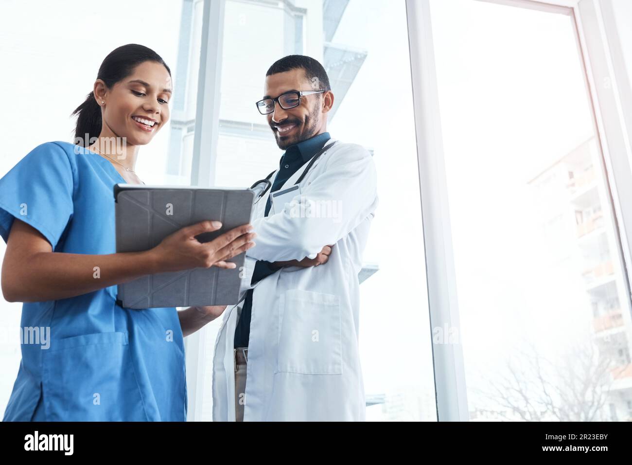 These are the results from the lab. two young doctors using a digital ...