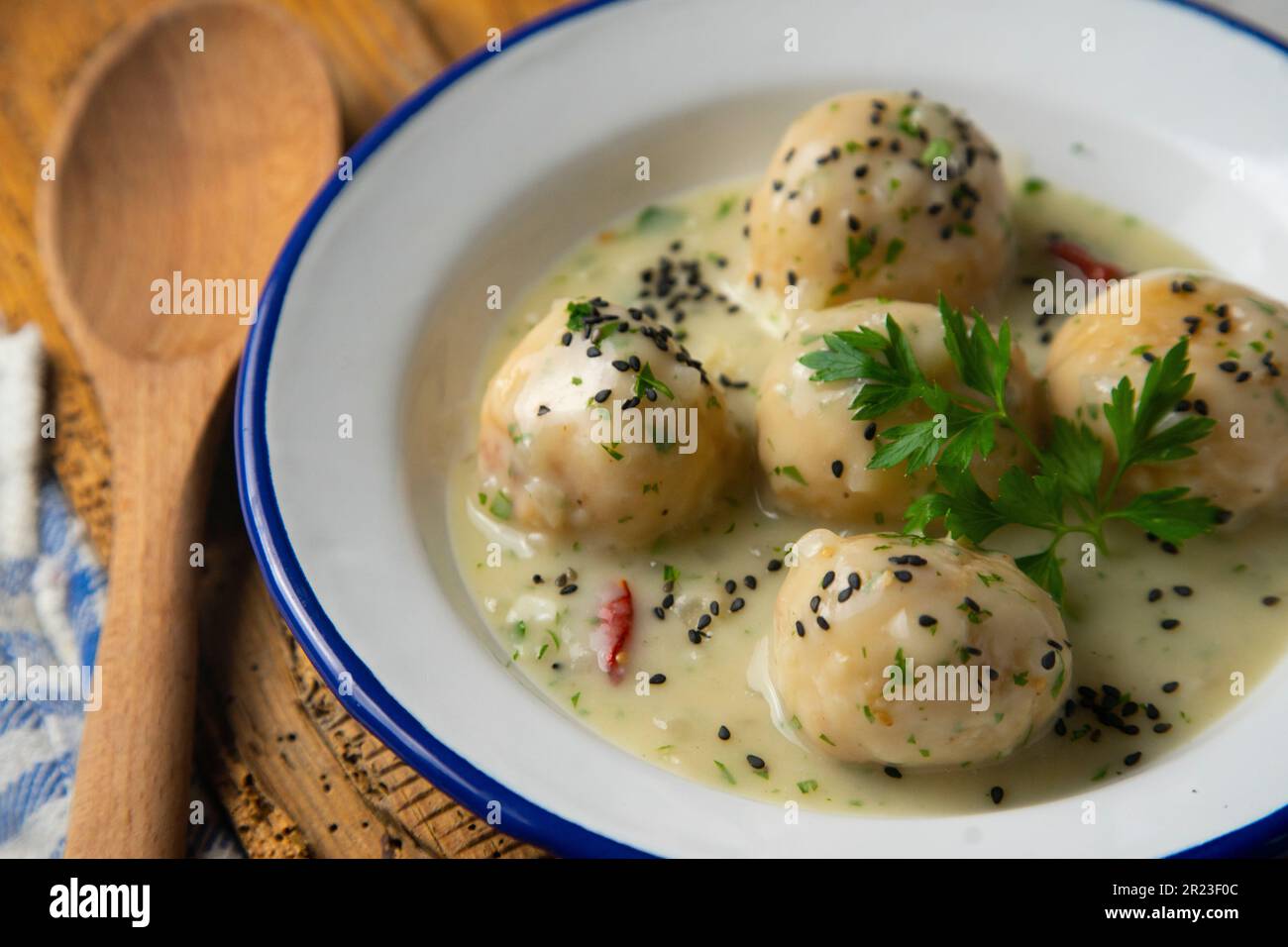 Fish meatballs with white wine sauce Stock Photo - Alamy