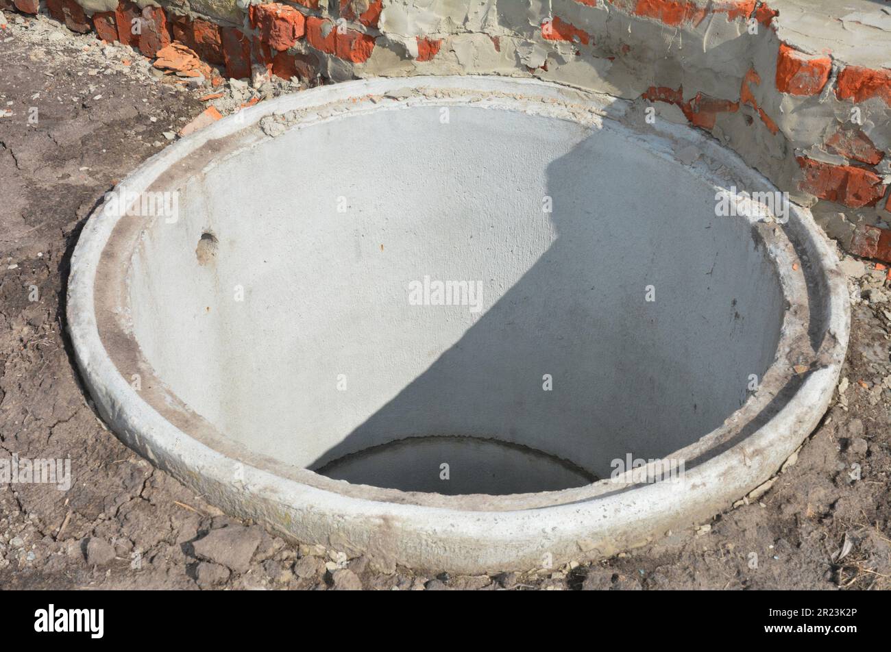 Concrete septic tank riser installation outdoors. Close up on septic