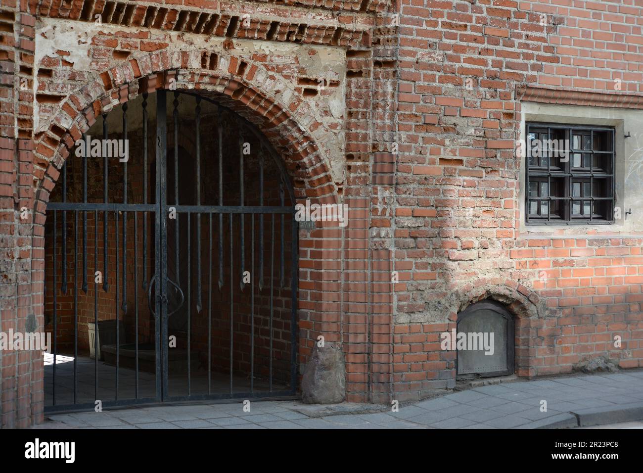 Old gate in a old building from red bricks. Stock Photo