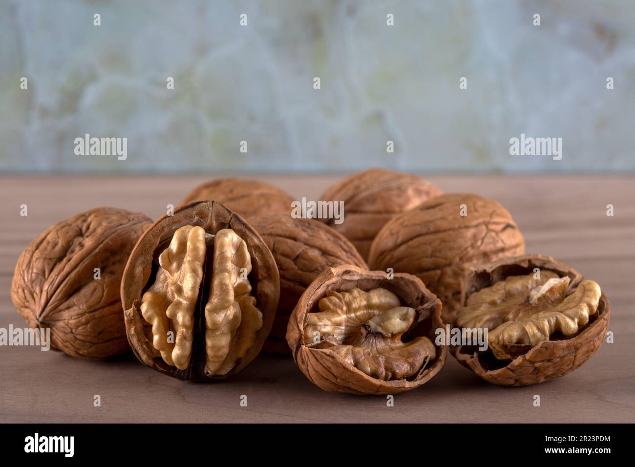 Cracked and whole walnuts together,close-up Stock Photo