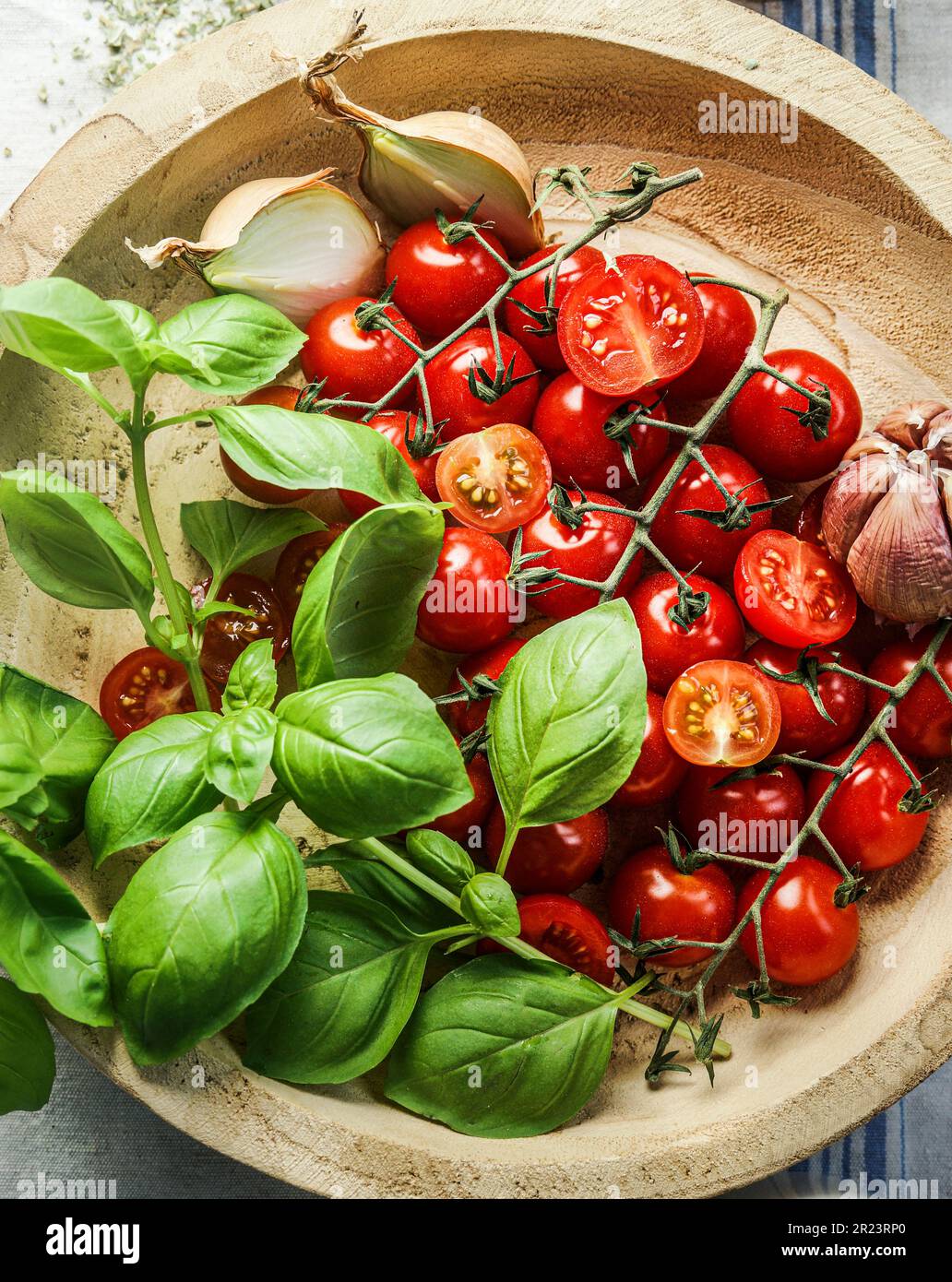 Tomatoes and basil in wooden tray, top view. Cooking ingredients for Italian food Stock Photo
