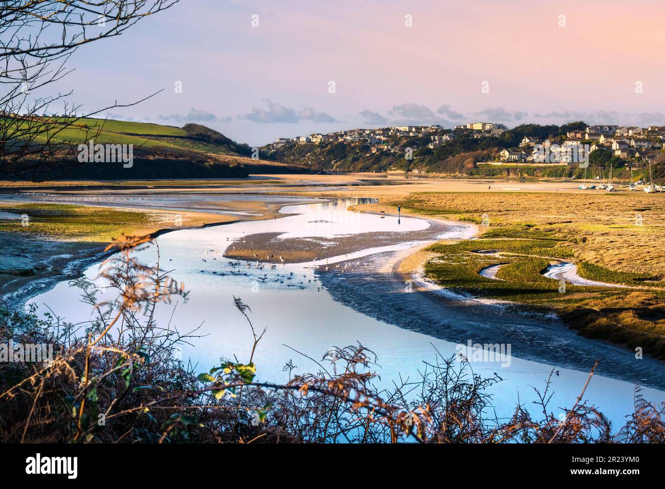 A view of late afternoon light over the Gannel tidal estuary at low tide in Newquay in Cornwall in the UK. Stock Photo