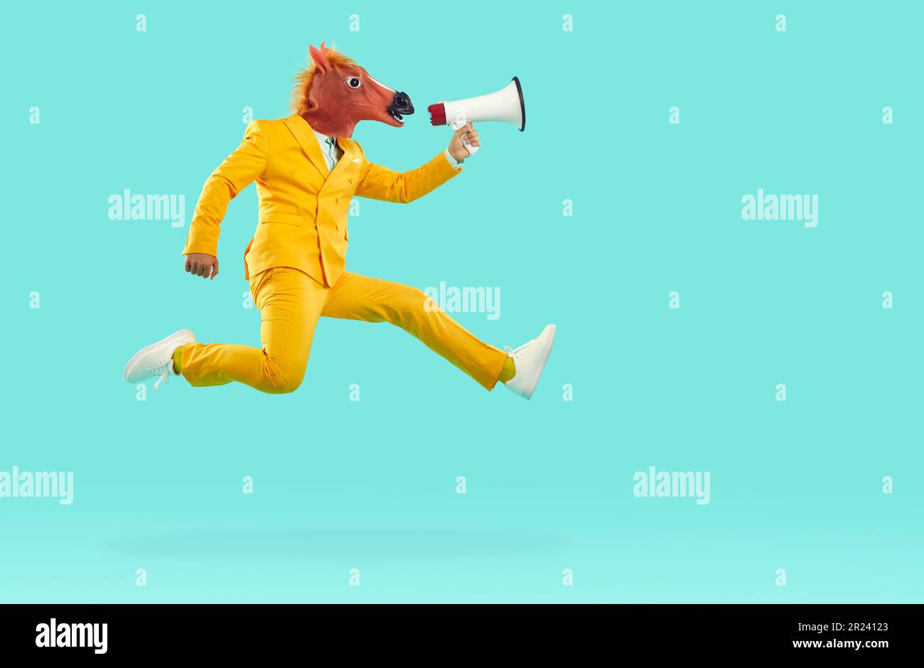 Man in yellow suit and funny horse mask flying in air and speaking