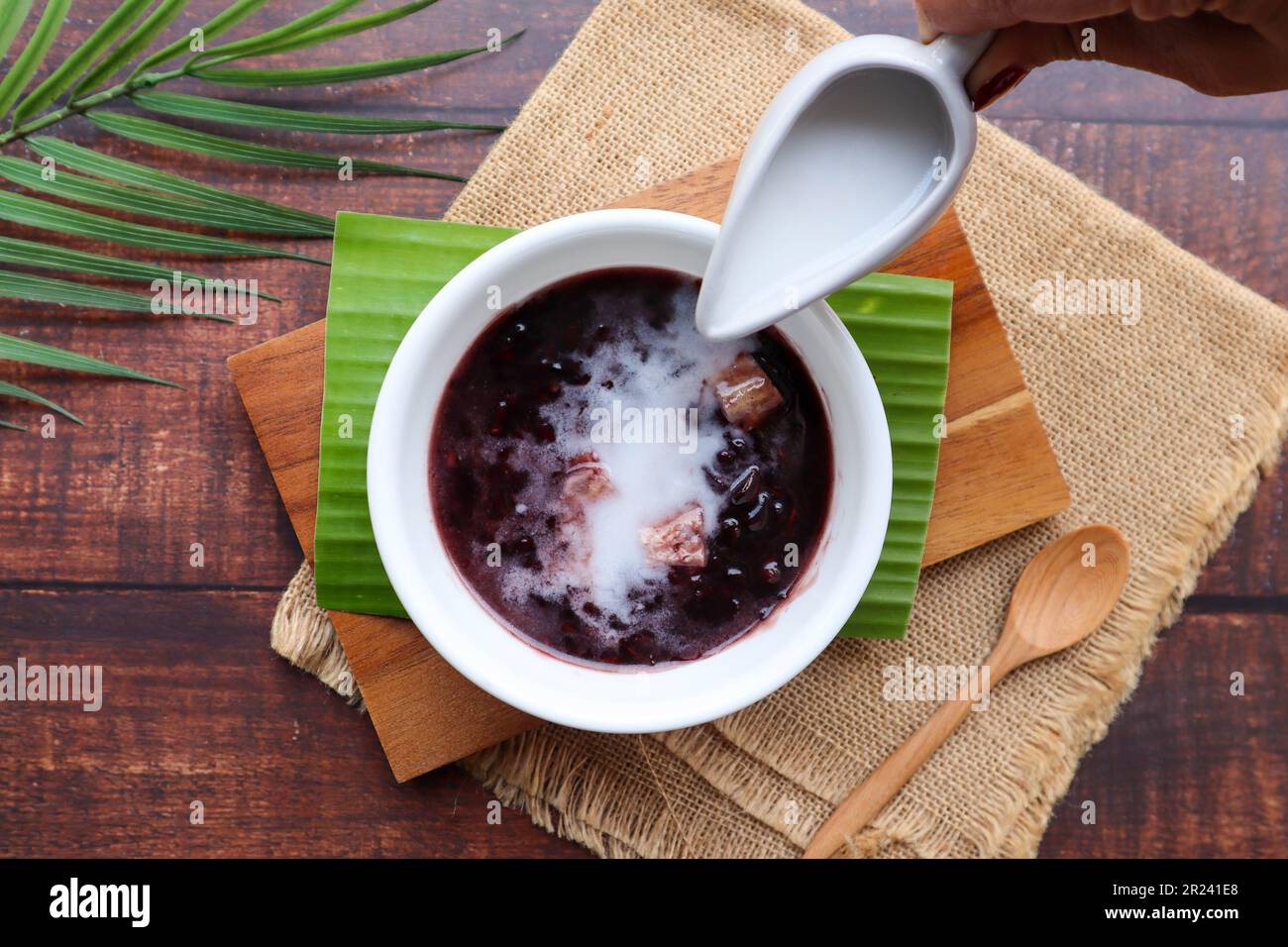 Black sticky rice pudding with taro and coconut milk at top view of wood table, Black glutinous