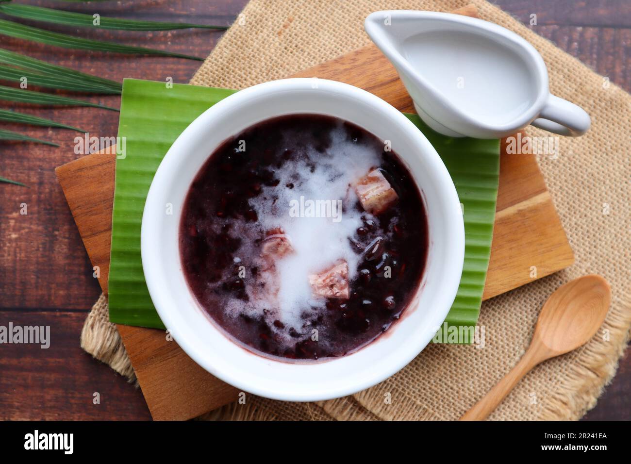 Sticky Rice With Taro Black sticky rice pudding with taro and coconut milk at top view of ...