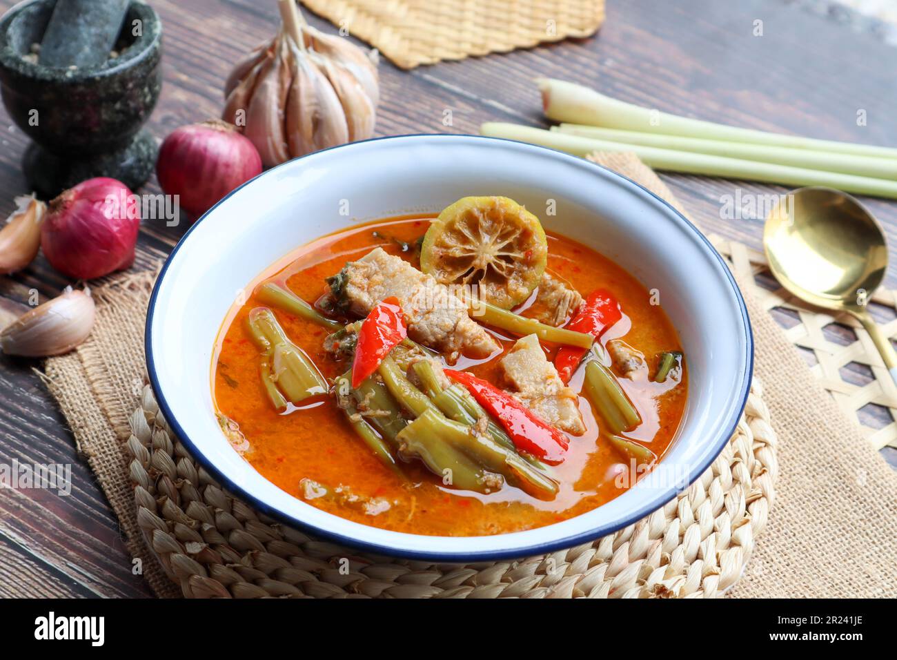 Thai red curry with morning glory and pork belly - Authentic Thai food called Kang Tay Po or Geang Tay po at close up view Stock Photo