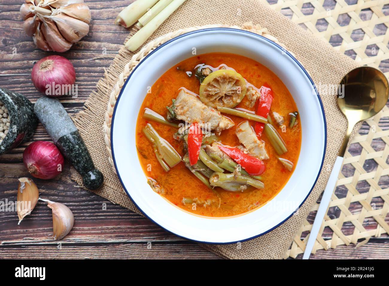Red curry with morning glory and pork belly - Authentic Thai food called Kang Tay po or Geang Tay po at close up view Stock Photo